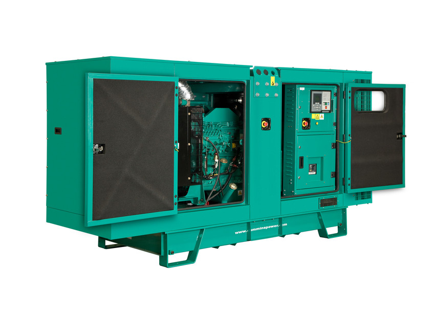 a green Cummins diesel generator with it's doors open