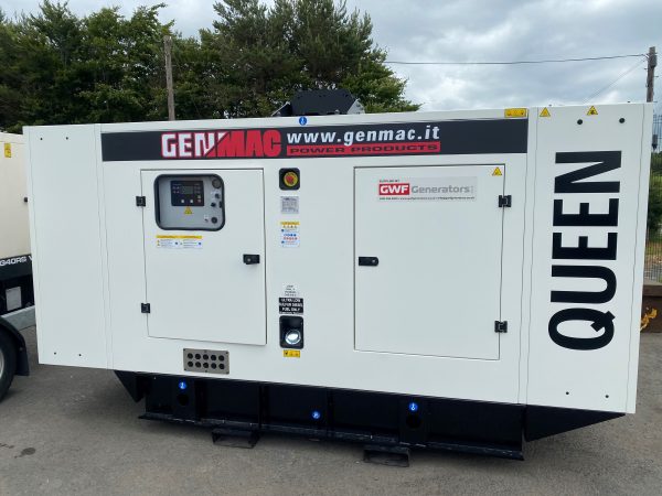 A white genmac generator in a yard